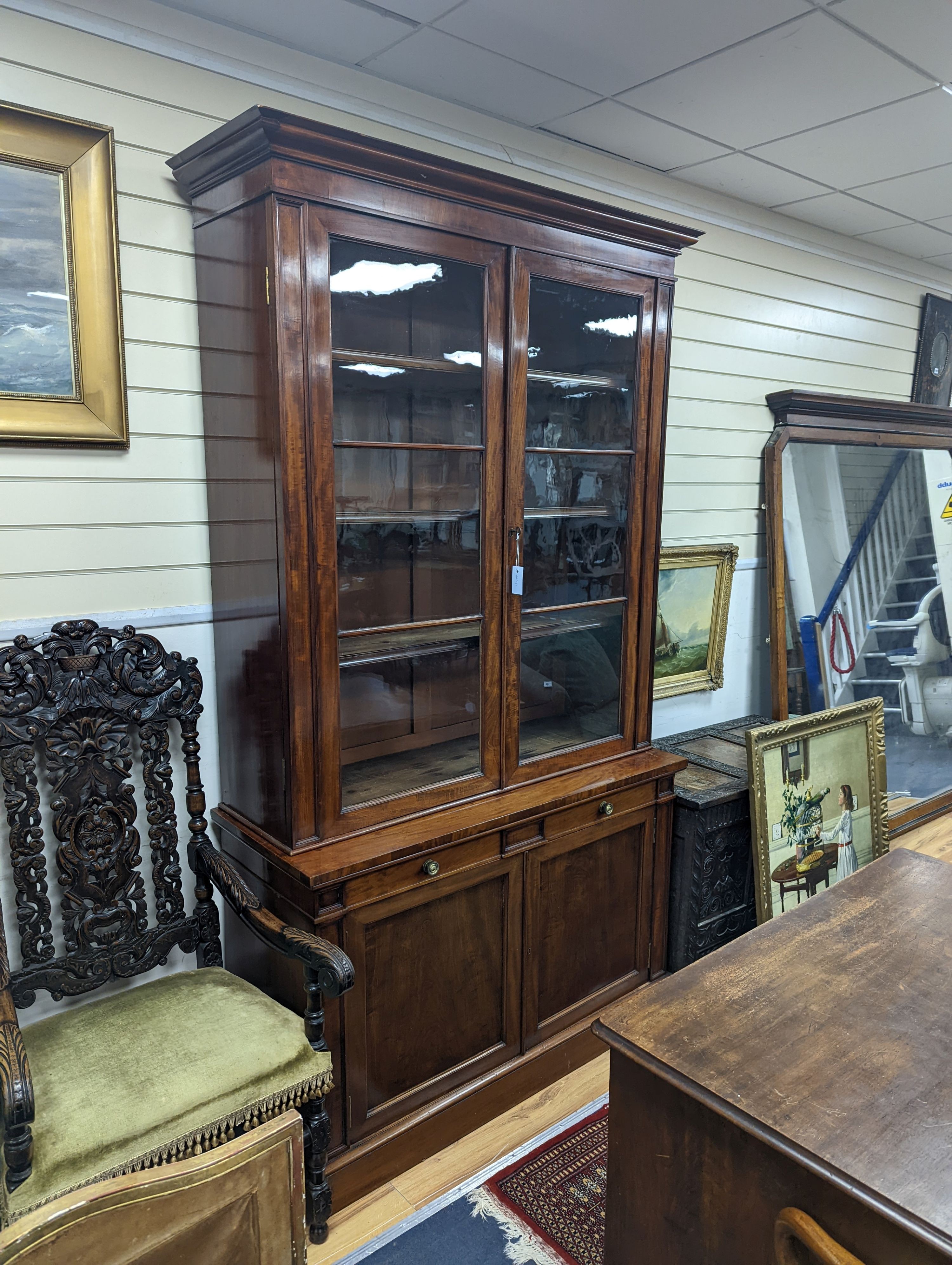 A Victorian mahogany bookcase fitted two drawers with panelled cupboard base, length 127cm, depth 49cm, height 228cm